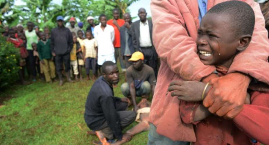 A boy cries before being circumcised in Shinyalu, in Kakamega, on August 8, 2014.  By Simon Maina AFPFile