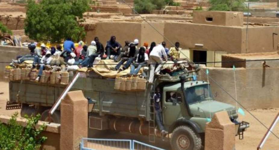 Migrants return from Libya to Niger on a truck in Agadez, in September.  By Boureima Hama (AFP/File)