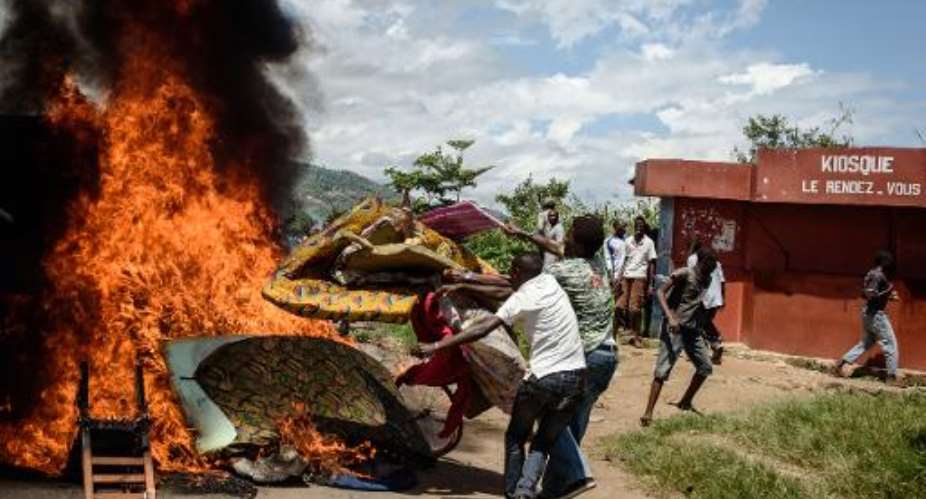 People burn mattresses looted from a local police post in Burundi's capital Bujumbura on May 13, 2015.  By Jennifer Huxta AFPFile