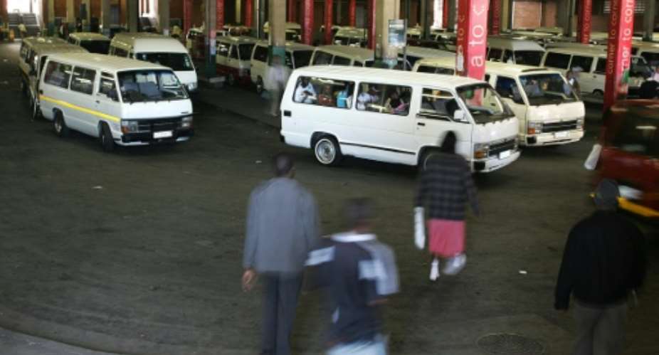 South Africans walk to minibus taxis at the Bree taxi rank on June 4, 2009 in Johannesburg.  By Paballo Thekiso AFPFile