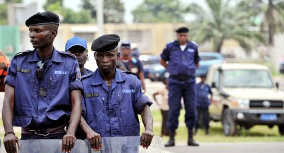 Police officers stand watch at a march in Kinshasa on February 16, 2013, to protest against the rule of President Joseph Kabila, in spite of a ban.  By Junior D. Kannah AFPFile
