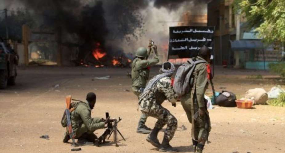 Malian soldiers fight while clashes erupted in the city of Gao on February 21, 2013.  By Frederic Lafargue AFP