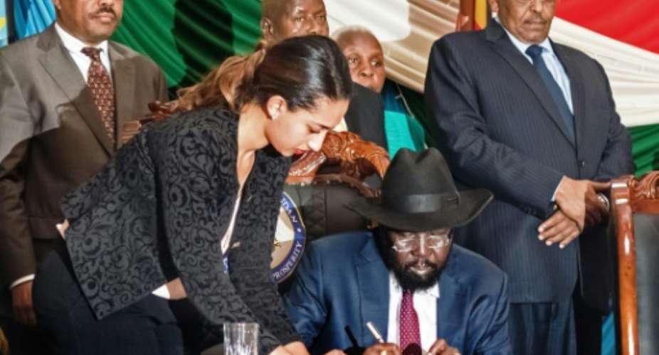 South Sudan's President Salva Kiir C signs a peace agreement in Juba on August 26, 2015, designed to end 20 months of civil war.  By Charles Lomodong AFP