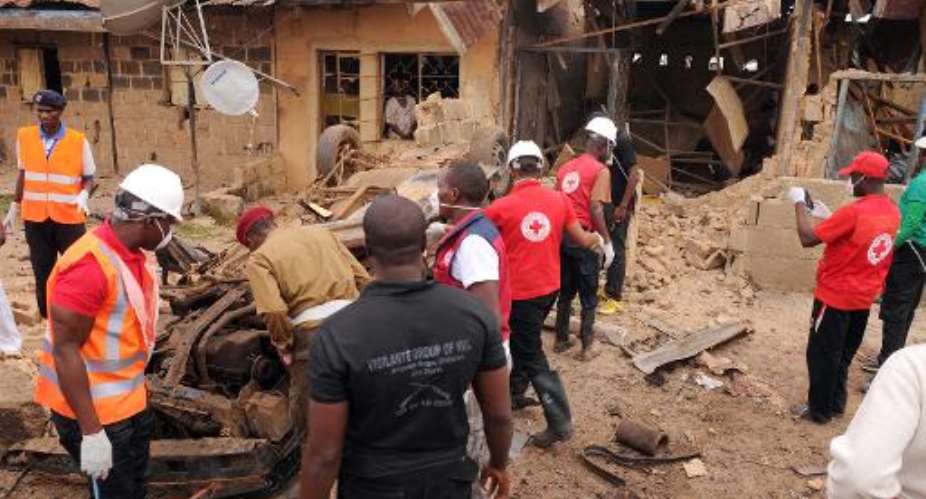File picture shows emergency response workers at the site of a car bomb blast in the central Nigerian city of Jos, on May 25, 2014.  By  AFPFile