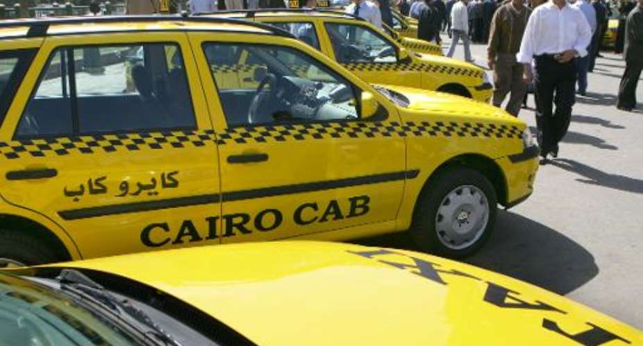 Taxi cabs aligned in one of Cairo's main squares on March 15, 2006.  By Khaled Desouki AFP
