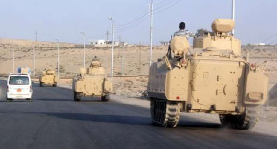 A convoy of Egyptian armoured vehicles moves along a road in El-Arish on the Sinai Peninsula on August 13, 2011.  By  AFPFile