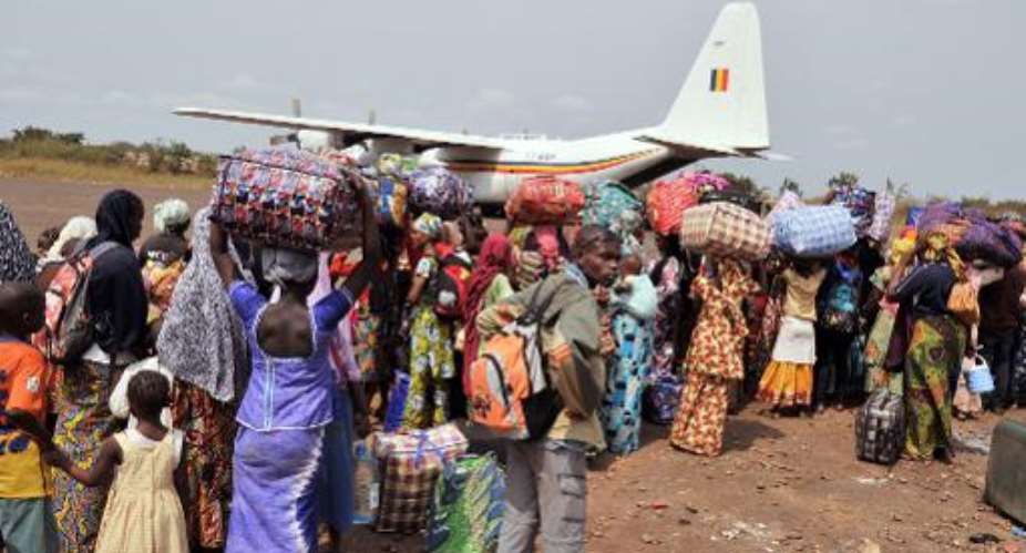 Chadian nationals and other foreign civilians, mostly Muslims, queue to board a plane bound for N'Djamena as they flee Bangui to avoid being targeted by Anti-Balaka Christian militants on January 31, 2014.  By Issouf Sanogo AFP