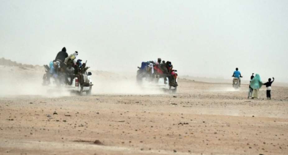 Migrants on pick-up trucks leave the outskirts of Agadez, Niger, heading across the Niger desert towards Libya and, ultimately, Europe.  By Issouf Sanogo AFPFile