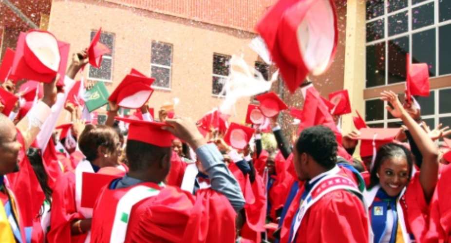 Graduating students of the American University of Nigeria in Yola celebrate after their commencement ceremony at the school on May 9, 2015.  By Emmanuel Arewa AFPFile