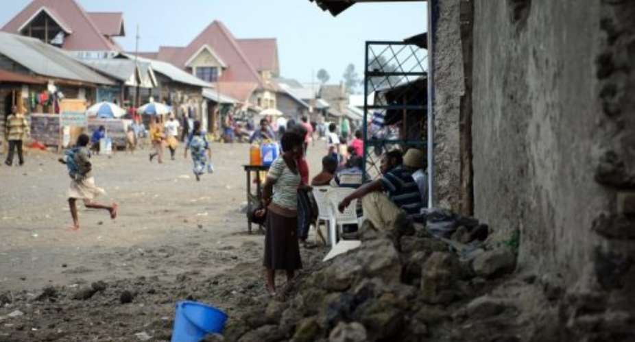 Residents of Kitchanga sit outside a small shop in eastern DR Congo on July 16, 2012.  By Phil Moore AFPFile