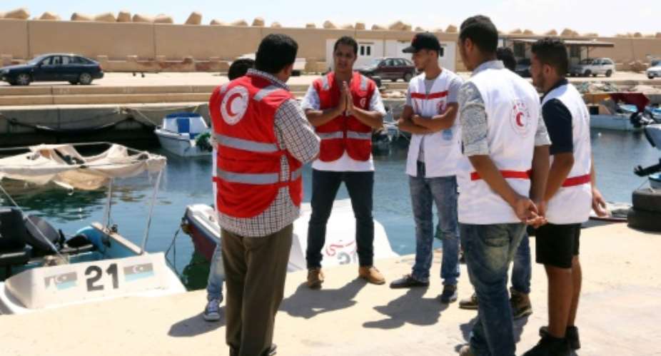 Members of the Libyan Red Crescent gather in the al-Khums district on August 30, 2015, ahead of collecting the bodies of migrants that had washed ashore on a beach after a boat carrying them sank.  By Mahmud Turkia AFPFile