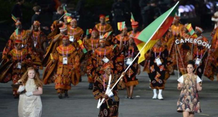 Cameroon's flagbearer Annabel Laure Ali C leads her delegation during the opening ceremony of the London 2012 Olympics.  By Gabriel Bouys AFP