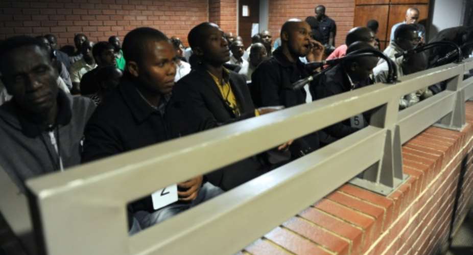 A picture taken on March 8, 2013 shows some of the South African police officers on trial in Benoni court over the death of Mido Macia, a Mozambican taxi driver who died in custody after being dragged behind a police van.  By Werner Beuke PoolAFPFile