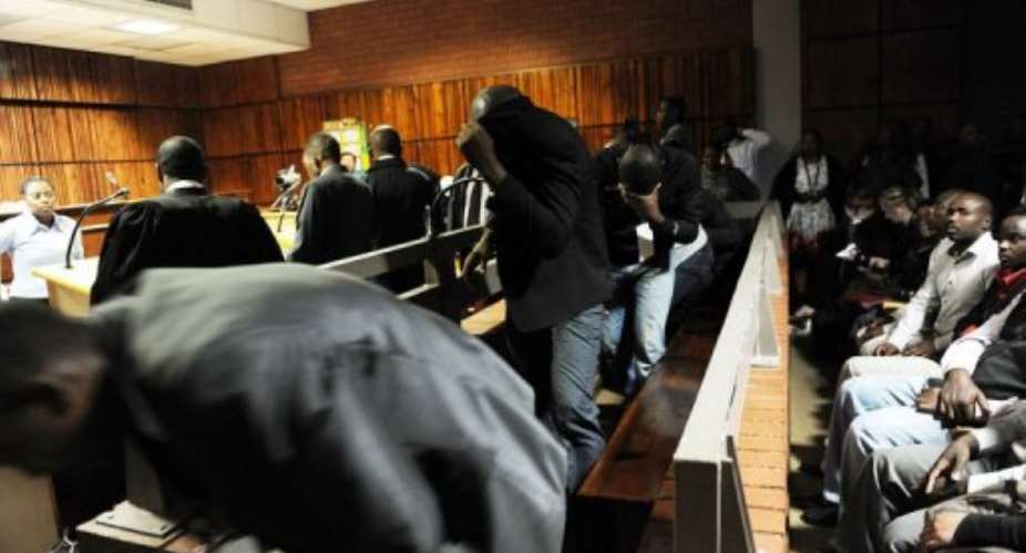 Policemen accused over the death of a taxi driver appear at Benoni Magistrate's Court in South Africa on March 11, 2013.  By Werner Beukes PoolAFPFile