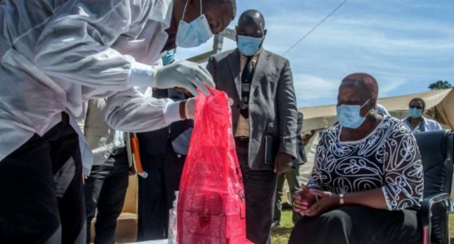 A batch of AstraZeneca from the AU had just a two-week shelf life, Health Minister Kumbize Kandodo, right, noted as the doses were incinerated.  By Amos GUMULIRA AFP
