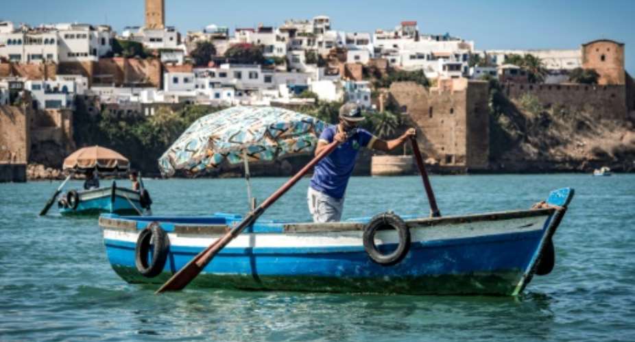 A boatman rows across the Bou Regreg river near the medieval Kasbah of the Udayas between the city of Sale and Morocco's capital Rabat.  By FADEL SENNA AFP