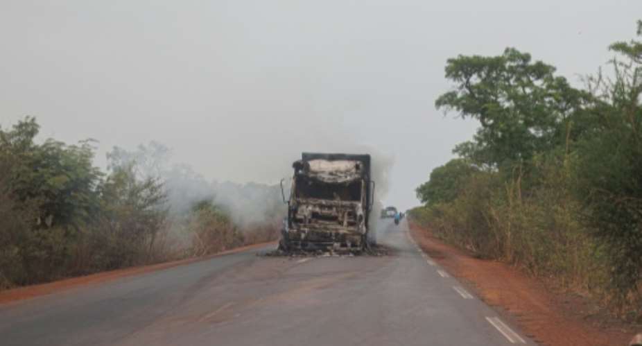 A burned truck is seen abandoned in the middle of the road leading to Sikasso, Mali in May 2026.  By - (AFP/File)