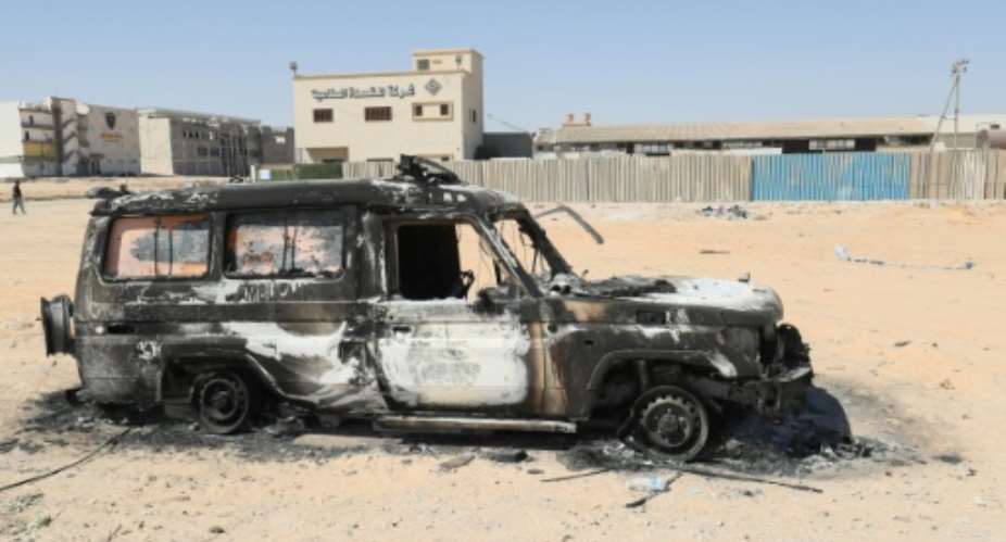 A car gutted by fire is pictured after two days of deadly clashes in Libya's capital.  By Mahmud TURKIA (AFP)
