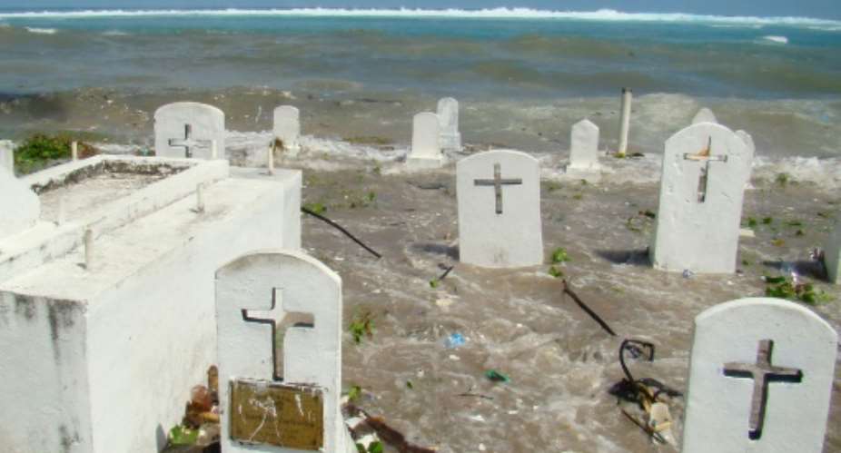 A cemetery in Majuro Atoll is flooded during high tide in the low-lying Marshall Islands, a Pacific atoll chain that sits barely a metre above sea level.  By GIFF JOHNSON AFPFile