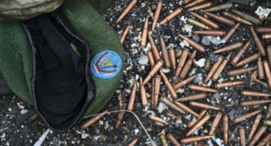 A crumpled Congolese army beret alongside cartridges near an abandoned, bullet-riddled military truck in Goma.  By Tony KARUMBA (AFP)