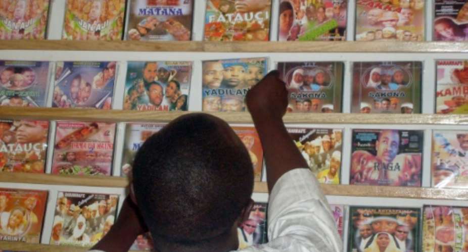 A customer searches for local Hausa films, known as Kannywood, popular among the residents of northern Nigeria's city of Kano.  By Aminu Abubakar AFPFile