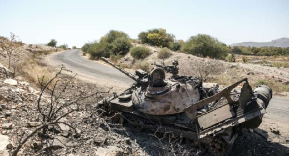 A damaged tank stands abandoned on a road near the Tigrayan city of Humera.  By EDUARDO SOTERAS AFP