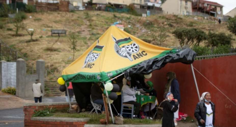 A day to forget: ANC supporters man a party stand outside a polling station in Hangberg near Cape Town.  By RODGER BOSCH AFP