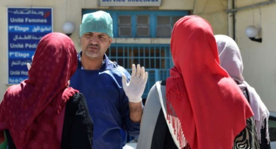 A doctor gestures outside a hospital in the Algerian town of Boufarik, as the country deals with a cholera outbreak, on August 28, 2018.  By Ryad KRAMDI AFP