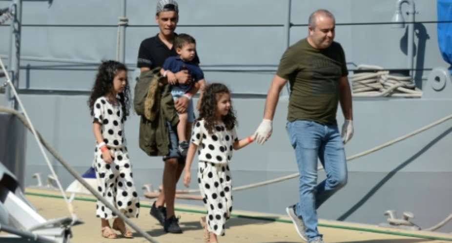 A family of migrants from the Aquarius rescue vessel disembark at Valletta port after nearly a week at sea.  By Matthew Mirabelli (AFP)