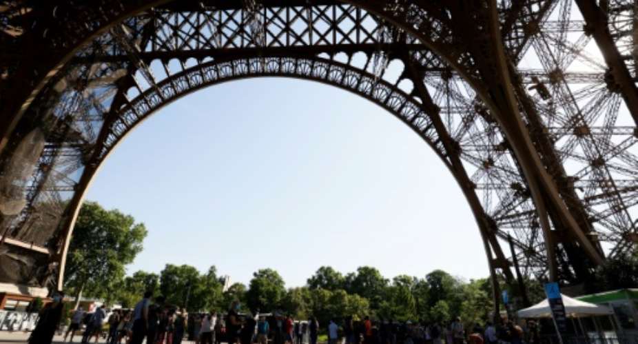 A few dozen tourists braved scorching heat in Paris to climb the Eiffel Tower's iron stairs.  By Thomas SAMSON AFP