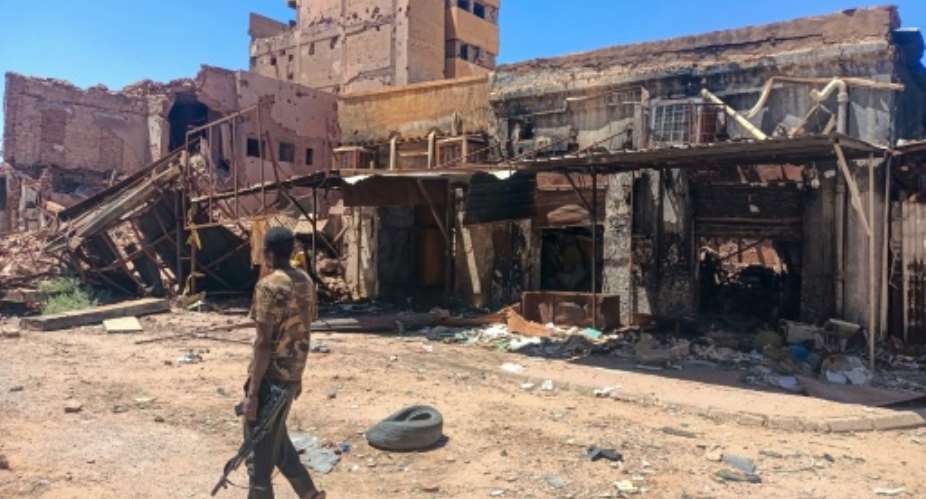 A fighter loyal to Sudans army patrols a market area in the capital Khartoum.  By - (AFP/File)