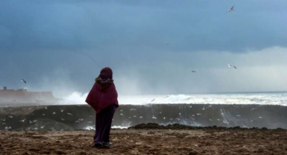 A file picture shows a Moroccan woman looking out to sea during a storm in Rabat on January 8, 2018.  By FADEL SENNA AFPFile