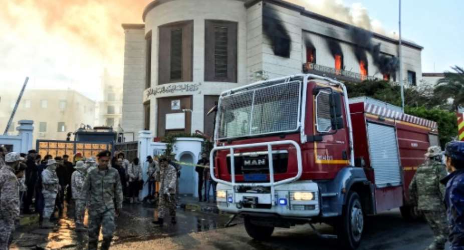 A fire truck and security officers outside Libya's foreign ministry in the capital Tripoli on December 25, after an attack that was claimed by Islamic State.  By Mahmud TURKIA AFP