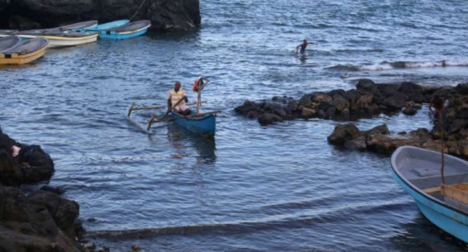 A fisherman steers a wooden boat called a kwassa kwassa towards the beach in Domoni, on the Comoran island of Anjouan.  By Ibrahim YOUSSOUF (AFP)