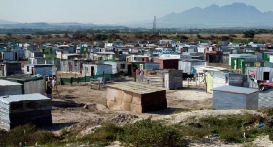 A forest of illegally-built shacks has sprung up near the township of Khayelitsha -- a symbol of South Africa's deepening land crisis.  By RODGER BOSCH AFP