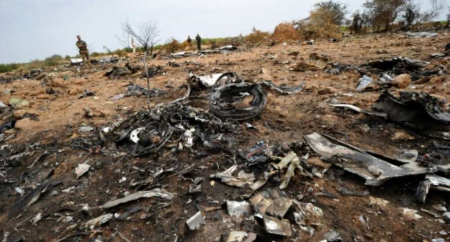 A French soldier looks at debris of the Air Algerie Flight AH 5017 in Malis Gossi region, west of Gao on July 26, 2014.  By SIA KAMBOU (AFP/File)