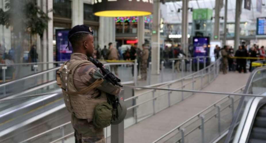 A French soldier stands guard after a knife attack at Paris's Gare de Lyon railway station.  By Thomas SAMSON AFP