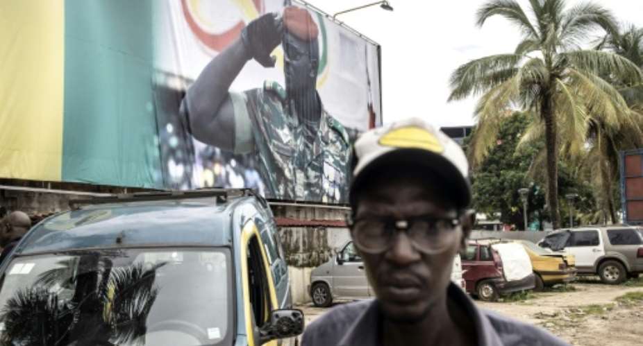 A giant billboard shows junta leader Doumbouya, who seized power accusing Conde of authoritarianism.  By JOHN WESSELS AFPFile