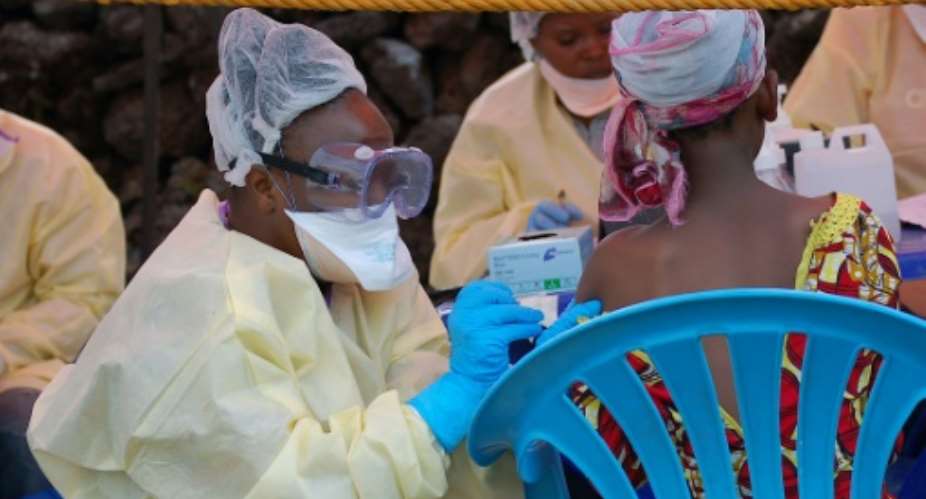 A girl receives a vaccine against Ebola from a nurse in Goma on August 7, 2019.  By Augustin WAMENYA AFPFile