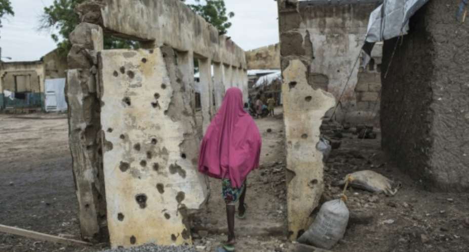 A girl walking through the Rann internally displaced persons camp in northeastern Nigeria after the January 2017 bombing by the Nigerian military that killed 112 civilians.  By STEFAN HEUNIS AFP