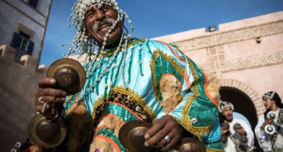 A Gnawa traditional group performs in the city of Essaouira to celebrate the decision of adding the Gnawa culture to UNESCO's list of Intangible Cultural Heritage of Humanity.  By FADEL SENNA AFP