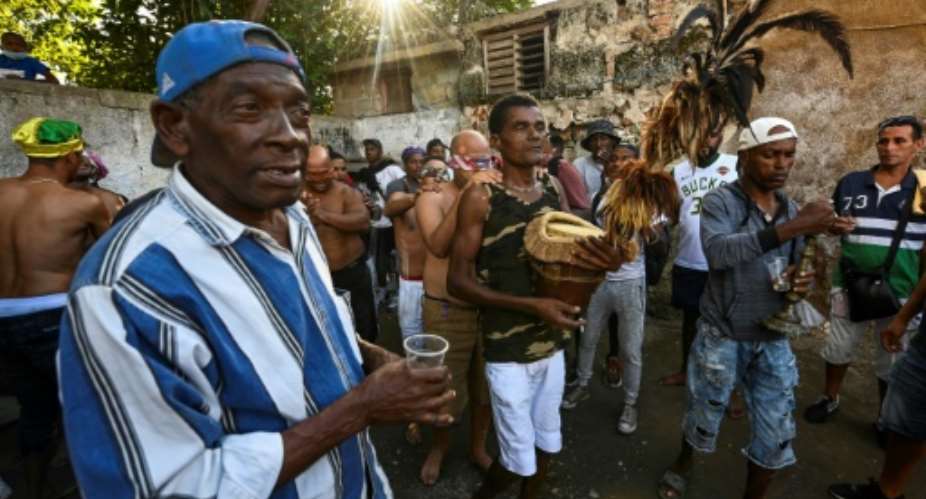 A group of initiates of the Cuban religion Abakua take part in the oath ceremony at the Efi Barondi Cama temple, known as a power.  By Yamil LAGE (AFP)