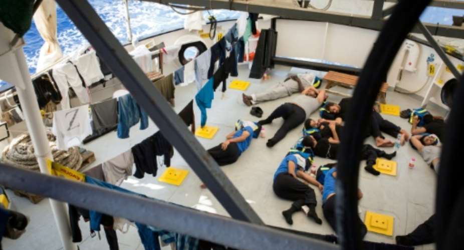 A handout photo by SOS Mediterranee shows migrants resting after being rescued by the Aquarius rescue ship in the Mediterranean Sea on September 20.  By Maud VEITH SOS MEDITERRANEEAFP