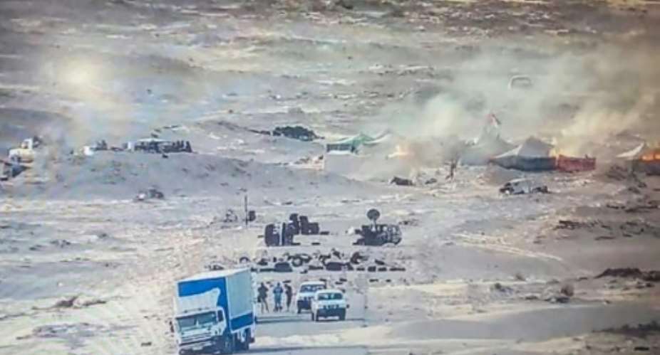 A handout picture published by the Royal Moroccan Army Facebook page on November 13, 2020, shows tents used by the Polisario Front ablaze near the Mauritanian border in Guerguerat after a military operation by Morocco.  By - AFP