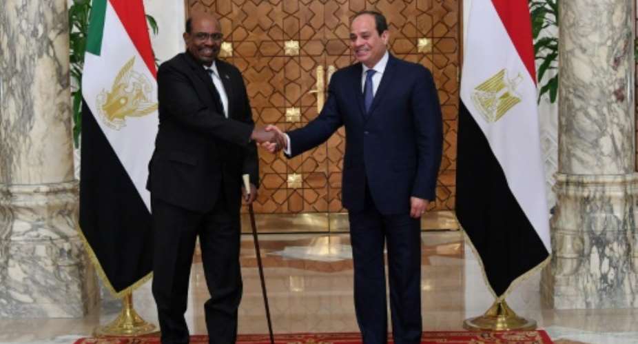 A handout picture released by the Egyptian Presidency on January 27, 2019 shows Egyptian President Abdel Fattah al-Sisi R meeting with his Sudanese counterpart Omar al-Bashir in the Egyptian capital Cairo..  By STRINGER EGYPTIAN PRESIDENCYAFP