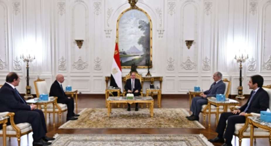 A handout picture released by the Egyptian Presidency on September 14, 2021, shows Egyptian President Abdel Fattah al-Sisi C meeting with Libyan military strongman Khalifa Haftar 2nd-R and Libyan Parliament speaker Aguila Saleh 2nd-L in Cairo.  By - EGYPTIAN PRESIDENCYAFP