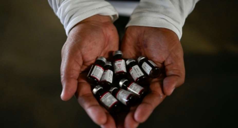 A health ministry worker showing vaccine doses for an immunisation campaign in Guatemala.  By JOHAN ORDONEZ (AFP)