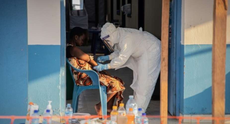 A healthcare worker taking samples from an Ebola patient in Bunia, northeastern DR Congo.  By Benediction MURHABAZI (AFP)