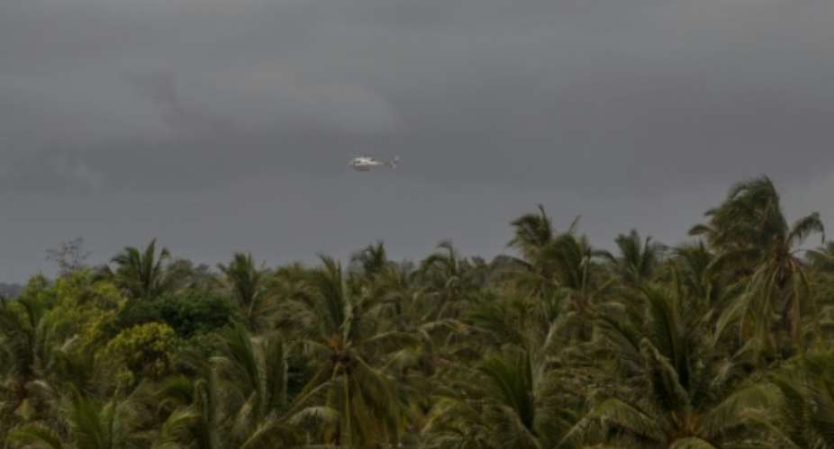 A helicopter flies over Pemba, Mozambique after deadly attacks by armed groups linked to Islamic State on March 30, 2021.  By Alfredo Zuniga (AFP)