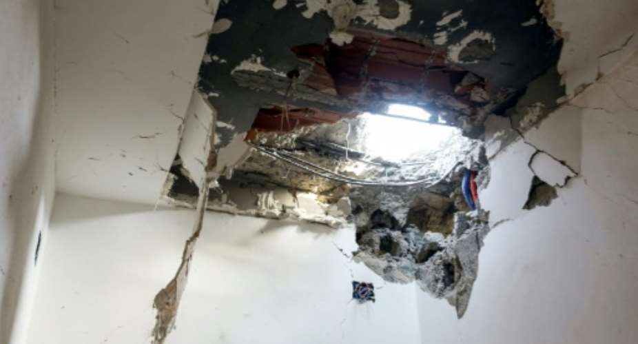 A hole in the ceiling of a house hit by a rocket in Ayn Zarah on the outskirts of the Libyan capital Tripoli, on September 4, 2018.  By Mahmud TURKIA AFP